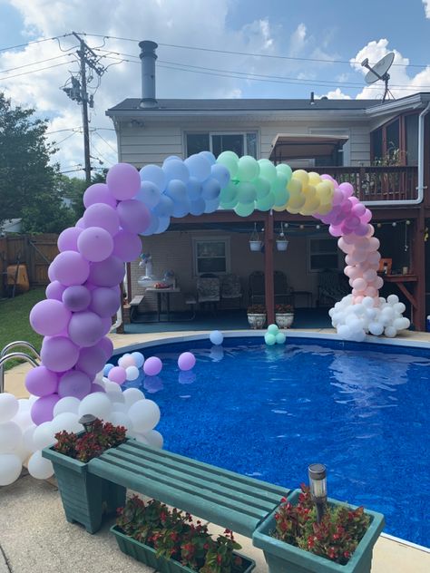 Rainbow colored balloons over a pool Balloon Arch Over Pool Diy, Pool Balloon Arch, Balloon Arch Over Pool, Balloon Arch Pool Party, Over The Pool Balloon Arch, Rainbow Pool Party, Balloon Garland For Pool Party, Pool Party Balloon Arch, Ballons Pool Decoration