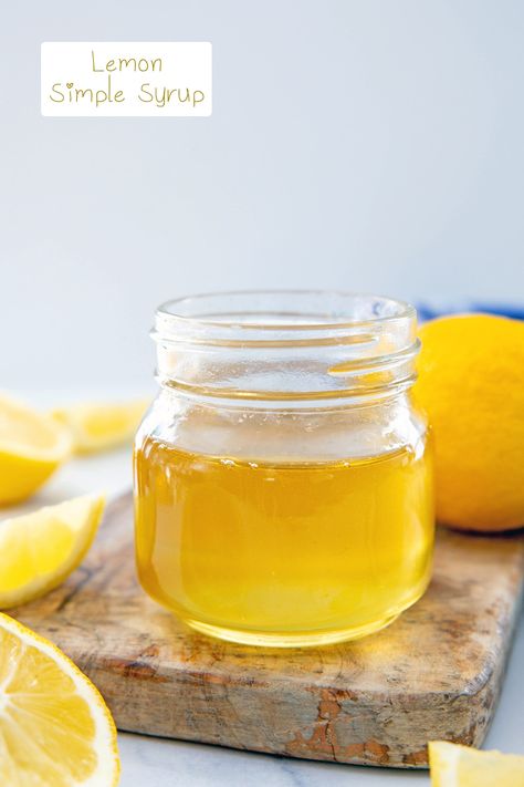 Head-on view of a small jar of lemon simple syrup with lemons all around and recipe title at top. Lemon Simple Syrup, Watermelon Syrup, Pineapple Syrup, Coffee Syrups, Rosemary Simple Syrup, Orange Syrup, Lemon Uses, Frozen Lemon, Lemon Syrup