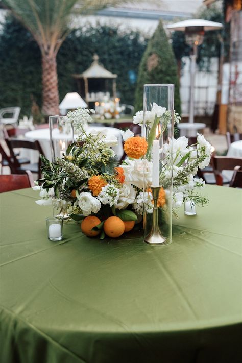 The color scheme of this wedding took center stage at Race and Religious. Pops of orange throughout the centerpieces atop linens in shades of green and white. We also loved using lamps on some tables for a warm and comforting feeling. The courtyard here dazzles, and these natural green and orange hues gave so much sophistication and charm. Green White And Orange Wedding, Green And Orange Wedding Theme, Orange Centerpieces, Orange Wedding Themes, Wedding Ambiance, Orange Hues, Green Table, The Courtyard, Orange Wedding