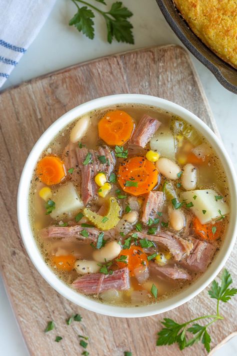 This hearty and comforting Slow Cooker Ham Bone Soup is a perfect way to use leftover holiday ham using staple pantry and fridge ingredients! Ham Bone Bean Soup, Ham Bone Soup Recipes, Ham Bone Recipes, Ham Bone Soup, Ham Soup Recipes, Bone Soup, Slow Cooker Ham, Pea And Ham Soup, Leftover Ham Recipes