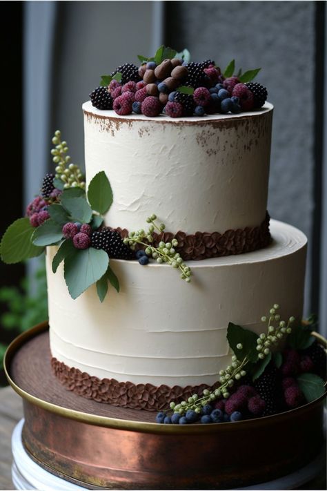 A two-tiered rustic wedding cake with a textured buttercream frosting on a white cake stand. The top tier is adorned with fresh berries and herbs, while the bottom tier is decorated with a rustic burlap ribbon. The cake is made with a rich chocolate cake recipe with a hint of espresso for added depth, giving it an elegant yet rustic look. Rich Chocolate Cake Recipe, Two Tiered Cake, Textured Buttercream, Chocolate Wedding, Berry Cake, Chocolate Wedding Cake, Rich Chocolate Cake, Fall Wedding Cakes