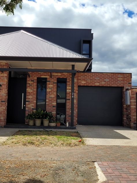 Red Brick House With Black Garage Doors, Red Brick And Black Exterior, Dark Red Brick House Exterior, Matte Black House Exterior, Old Brick House Exterior Makeover, Colorbond Roofing, Orange Brick Houses, Brick Shed, Brick House Colors