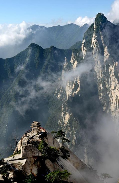 Clouds and thick mist shroud the peaks of Mount Hua, or Hua Shan, east of Xi’an city in Shaanxi province. Mount Hua is one of China’s five Great Mountains and has a long history of religious significance. Rainfall increases when summer begins, as do the clouds, creating a scene very much like a fairyland full of natural wonders. Mountain Texture, Mount Hua, Altai Mountains, Worlds Collide, Long History, Fairy Land, The Clouds, Tourist Attraction, Natural Wonders