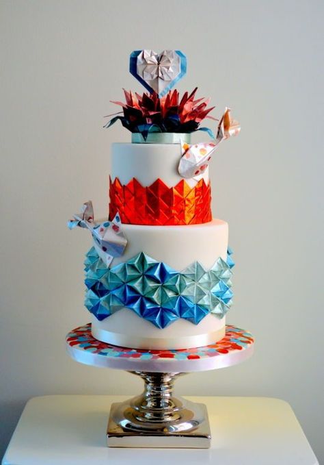 a colorful wedding cake decorated with origami and koi fish for a quirky Japanese wedding Japanese Wedding Cakes, Geometric Cake Design, Colorful Wedding Cake, Origami Cake, Strawberry Wedding Cakes, Blue Origami, Crazy Wedding Cakes, Geometric Cake, Cake International