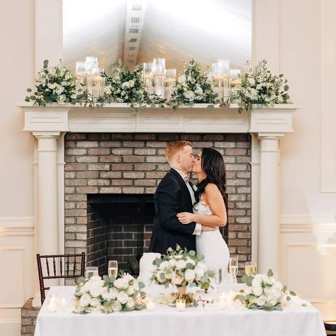 Fireplace Mantel Wedding Decor Bride And Groom Table In Front Of Fireplace, Fireplace Wedding Reception, Mantel Decorating Ideas Wedding, Fireplace Ceremony Wedding, Mantle Wedding Decor, Wedding Mantel Decor, Wedding Mantle Decor, Fireplace Wedding Decor, Mantel Candles