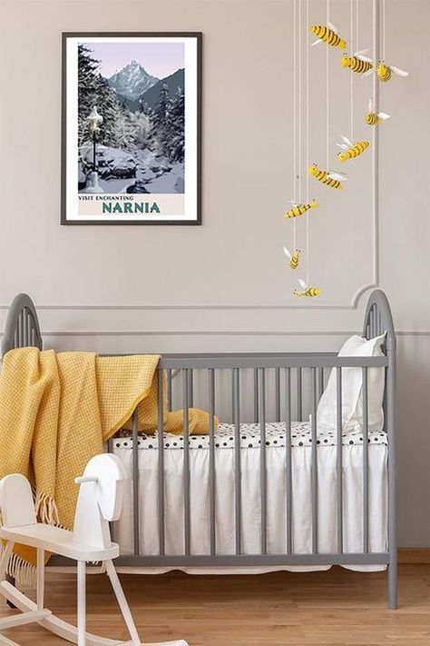 an ethereal nursery with dove grey paneled walls, a vintage grey crib, a bee mobile and some yellow textiles Chronicles Of Narnia Art, Ethereal Nursery, Grey Yellow Nursery, Bee Mobile, Narnia Art, Striped Accent Wall, Yellow Crib, Yellow Nursery Decor, Yellow Accent Walls