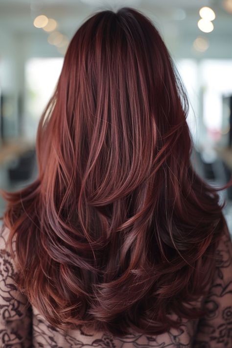 Woman with long, wavy, dark red hair in a well-lit salon. Red Hair Variations, Cherry Ombre Hair, Rose Brown Highlights, Strawberry Balayage, Chocolate Cherry Brown Hair, Brown Hair Styles, Deep Auburn Hair, Cherry Brown Hair, Reddish Brown Hair Color