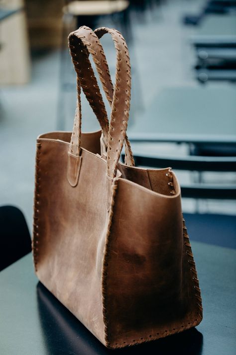 This whip-stitched leather tote is the go-to bag for everyday use. It includes a detachable leather zip closure pouch of the same color to grab if you just want to run to the gym or get a coffee to go without carrying your entire bag. Carry this bag on your shoulder or on your arm, it looks great dressed up or down. We love love love this bag, the whip-stitched detail adds just the right amount of style. Measurements are 13 x 8.7 x 12 inches Hand made from 100% Italian Leather 100% cowhide leath Distressed Brown Bags With Leather Lining For Everyday Use, Rustic Brown Leather Bag, Distressed Brown Leather Bag For Everyday Use, Leather Bags, Rustic Leather-lined Bag For Everyday Use, Brown Leather Hand-stitched Bag, Leather Purse Diy, Rustic Leather Bag, Personalized Leather Handbag