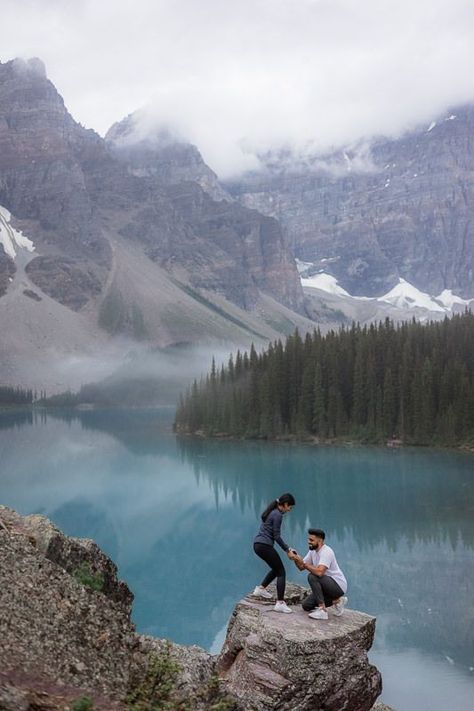 Surprise proposal at Moraine Lake mountain top. The surprise was SO good! Mili had no clue whatsoever. Niraj had packed some clothes for them to change into, so they went back down and changed before we did a little photo session and hung out around Moraine Lake. The weather was so nice, it was threatening thunderstorms all day as per the mountains do and you never really know what's going to happen. Mountain Top Proposal, Cringey Wedding, Proposal Locations, Mountain Engagement Shoot, Engagement Shoot Outfit, Watch The Sunrise, Maligne Lake, Engaged Couples Photography, Surprise Engagement