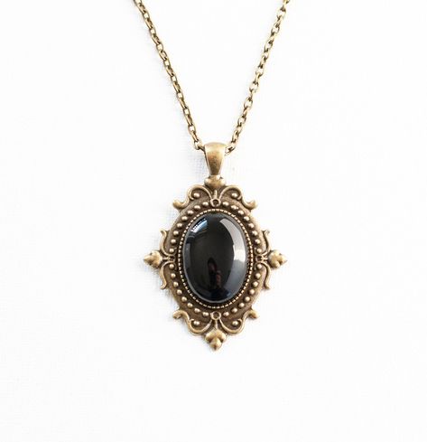 This Victorian inspired necklace is made from antique bronze chain and a black onyx cabochon housed in an ornate filigree setting. -the chain is 18 inches long -the pendant is approximately 2 inches long and 1.5 inch wide including the setting -lobster claw closure SHIPPING: Default shipping is by regular mail, which does not have tracking, shipping times are as follows: US: 1-3 weeks Canada: 1-2 weeks Europe: 2-4 weeks If you would like to add tracking for your parcel, please upgrade to Expedit Old Pendant Necklace, Vintage Necklace Antiques, Golden Skin, Black Gold Necklace, Jewelry Piercing, Victorian Necklace, Vintage Pendant Necklace, Raw Crystal Necklace, Filigree Jewelry