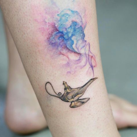 I absolutely LOVE this tattoo! I really like the colorful mist thingy. Reminds me of Aladdin :) Genie Tattoo, Aladdin Tattoo, Cute Disney Tattoos, Princess Tattoos, Jasmine Tattoo, Disney Inspired Tattoos, Tattoos Disney, Disney Sleeve Tattoos, Disney Tattoo Ideas