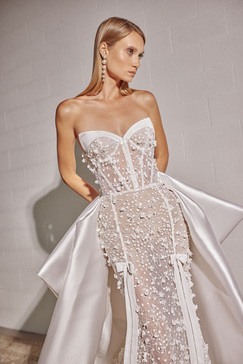 Utterly chic, the contrasting satin overskirt boasts a dramatic train and oversized back bow | bow outfits, bridal cape, 2025 bridal dress trend, lace bridal gown, wedding dress with bow train, satin wedding dress, pearl wedding dress, strapless wedding dress, trumpet wedding dress, trumpet wedding dress lace, trumpet wedding dress plus size, fit and flare wedding dress, fit and flare wedding dress strapless, sparkly wedding dress, wedding dress with overskirt, luxury wedding dress,modern bride Trumpet Wedding Dress Plus Size, Trumpet Wedding Dress Lace, Summer Wedding Attire, Beach Wedding Outfit, Wedding Guest Outfit Winter, Winter Wedding Outfits, Wedding Outfits For Women, Wedding Guest Outfits, Pearl Wedding Dress