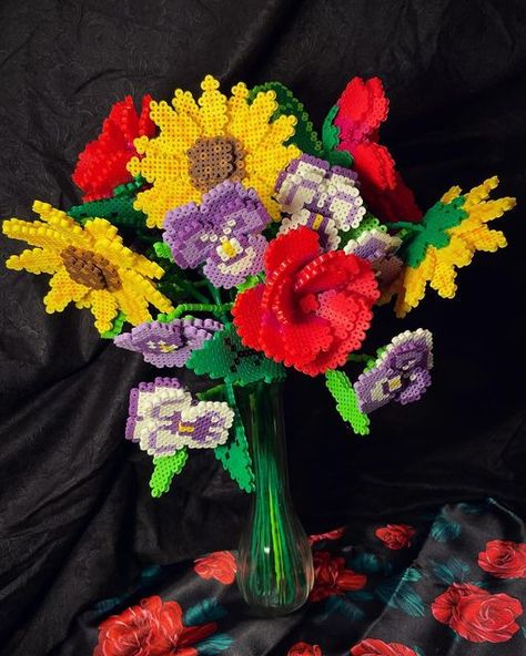 Amy Byte on Instagram: "Not your ordinary bouquet, these flowers are all made from perler beads! This took 3 days to make and probably around 30 hours. 4 stems of sunflowers, 5 stems of roses, and 3 stems of pansies. I’ll be posting a YouTube tutorial of the process soon so stay tuned! #perlerbeads #pixelart @perlerbrand" Perler Bead Bouquet, Perler Bead Flower Bouquet, Sunflower Perler Bead Patterns, Perler Bead Flowers, Flower Perler Beads, Perler Bead Flower, Hama Beads 3d, Beaded Bouquet, Seed Bead Projects