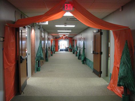 Hallway decor featuring plastic tablecloth tents and homemade trees. Camping Hallway Decorations, Vbs Decorating Ideas Camping Theme, Tablecloth Tent, Campfire Light Vbs Decor, Vbs Camping Theme Decorations, Camping Theme School Hallway, Camping Theme Hallway Decorations, Cokesbury Camp Firelight Vbs, How To Divide A Room Ideas