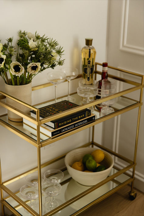 Embrace the essence of French modern living through our #mnFrenchModern project. Bar Cart Alternative Uses, Bar Cart In Dining Room Ideas, How To Style A Bar Cart, Mini Bar Cart Ideas, Gold Apartment Decor, Bar Cart Aesthetic, Aesthetic Bar Cart, Bar Cart Gold, Gold Bar Cart Styling