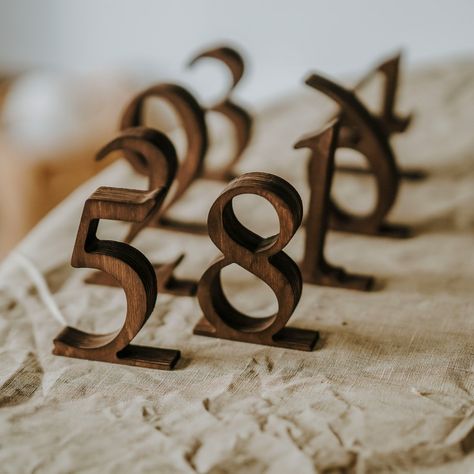 Rustic Wooden Wedding Table Numbers Add elegance and rustic charm to your wedding with our Wooden Wedding Table Numbers. Perfect for rustic-themed weddings, these custom wooden signs are not just functional but also beautifully designed to complement your table decor. They leave a memorable impression on your guests with their high-quality craftsmanship. Materials: Crafted from durable plywood in rustic brown and black, and sleek ashwood in white, our table numbers are built to last and look gre Wedding Table Number Ideas Rustic, Wedding Table Numbers Elegant, Fall Table Numbers Wedding, Farmhouse Table Wedding Decor, Farmhouse Table Wedding, Rustic Table Numbers Wedding, Wooden Wedding Table Numbers, Restaurant Table Numbers, Unique Table Numbers Wedding