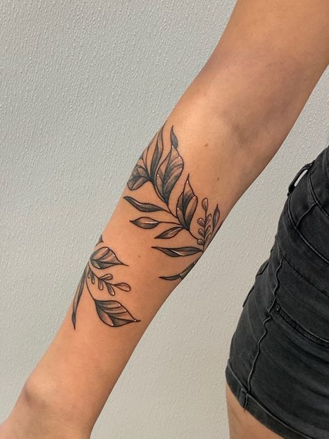 Leafs, wrap tattoo, arm tattoo, girl tattoo, wrist tattoo, black and white tattoo, floral tattoo Black And White Wrist Tattoo, Leave Tattoo Arm, Leaf Arm Tattoos For Women, Leaf Arm Band Tattoo, Leaves Wrist Tattoo, Leaf Tattoo Wrist, Tattoo Leaves Arm, Black And White Sleeve Tattoo Women, Wrap Around Leaf Tattoo