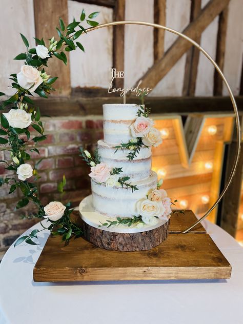 3 tier semi-naked wedding cake displayed on the hoop stand decorated with fresh flowers & personalised topper 3 Tier Naked Wedding Cake, Naked Wedding Cake With Flowers, Semi Naked Wedding Cake, Bridal Cakes, 2 Tier Wedding Cakes, Fancy Wedding Cakes, Wedding Cake Display, Diy Backyard Wedding, Boho Cake