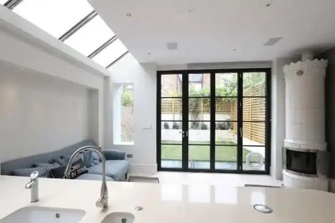 contemporary kitchen extension with modern and minimal design and a black steel look aluminium bifold patio door Sofa In Kitchen Ideas, Sofa In Kitchen, Bifold Door Ideas, Doors To Patio, Kitchen Glass Doors, Tropical Farmhouse, Bifold Windows, Aluminium Bifold Doors, Bi Folding Doors