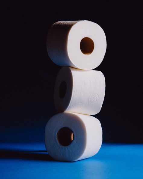 A tower of three Renova toilet paper rolls is elegantly stacked against a deep blue, almost black background. The subtle lighting accentuates the soft texture and signature embossed logo, epitomizing the brand's sophisticated charm Black Toilet Paper, White Toilet, Home Aesthetics, Unique Looks, Black Toilet, Skin Care Lotions, Paper Magic, Make A Difference, Recycled Paper