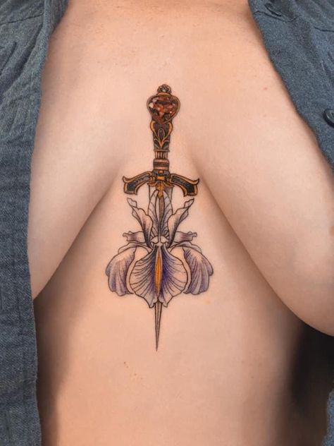 Dagger, iris, ruby, jewels, gold, blade, breast, tattoo, purple, sharp, delicate, beautiful, amazing, inspiring, feminine, confident. Dragonfly Dagger Tattoo, Dagger Chest Tattoo Female, Dragon Dagger Tattoo, Dagger Tattoo Feminine, Dagger Sternum Tattoo, Blade Tattoos For Women, Breast Tattoos For Women, Feminine Dagger Tattoo, Sternum Piece