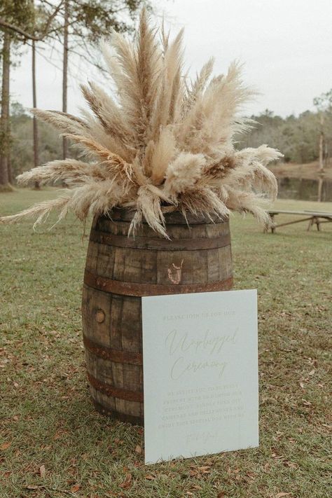 Pampas Grass Wedding Arrangements, Western Pampas Grass Decor, Rustic Boho Reception Decorations, Pampas Grass Whiskey Barrel, Western Wedding Bar Ideas, Pampas Grass Barrel Arrangement, Tan Western Wedding, Western Isle Decorations, Neutral Western Wedding