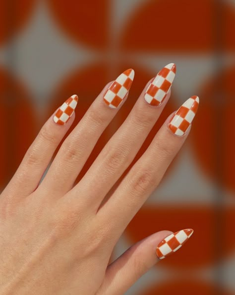 Burnt Sienna Checkers – Warm Orange and White Checkered Nail Bold sienna orange meets clean white lines in this classic checker pattern inspired by the color stories of mid century modern decor. Choose your preferred nail shape and length! Designed by Keara (@thenailvibes) Order Details Made to order by hand. 7-28 day lead time. Lead times can vary due to seasonal traffic and shipping delays.In a rush / need by a targeted date? Please let us know and we can accommodate for a fee. New clients wil Chex Nail Art, Retro Checkered Nails, Orange And White Checkerboard Nails, Red And White Checkered Nails, Wavy Checkered Nails, Checkered Almond Nails, Orange Checkered Nails, Checkered Flag Nails, Retro Nails Vintage