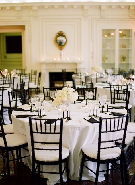 Black chairs white pads white tablecloth this has no overlay but black napkins @Lauren Palmaccio White Linen Black Napkin Wedding, White Table Black Napkins Wedding, White Tablecloth Black Runner, Black And White Wedding Table Linens, Wedding Table Black Chairs, Black Chavarri Chairs Wedding, Black Chiavari Chairs, White Tablecloth Black Napkin Wedding, White Tablecloth With Black Napkins