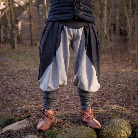 Pondering the origins of Viking pants hints at a blend of fashion and practicality. Baggy pants, like our Ignis Wool Pants, offered space for showcasing wealth through embroidery and additional fabric. Yet, their versatility suited the ever-changing Scandinavian climate. Our Ignis Wooly Pants embody this ethos, crafted for durability and designed to be complemented by woollen leg wraps, echoing the Viking silhouette. #EpicArmoury #LARP #VikingCosplay Viking Silhouette, Viking Pants, Viking Cosplay, Leg Wraps, Larp Costume, Medieval Costume, Baggy Pants, Baggy Pant, Wool Pants