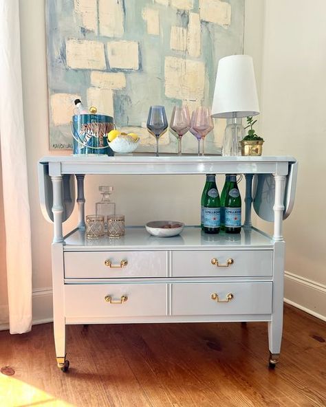 Heirloom House on Instagram: "Get ready to serve in style with the fabulous rolling cart! 🤩 Now available for sale.

Finished in a luxurious high gloss light blue paint with new polished brass hardware and a touch of PINK added to the silver drawer, this cart is ready to be the center of your next party! 🥂 Finished on both sides plus drop leaf ends makes it a versatile piece to move around your home!

Please message me with any questions :)" Blue Bar Cart, Light Blue Paint, Coffee Bar Cart, Fine Paints Of Europe, Light Blue Paints, College House, Bamboo Bar, Vintage Bar Carts, Bar Cart Styling