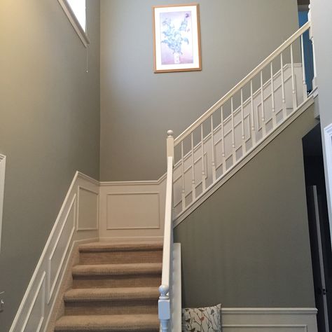 Benjamin Moore River Reflections updates a sage green foyer. Sage Green Stairs And Landing, Sage Green Stairway, Sage Green And White Hallway, Sage Green Panelling Hallway, Sage Green Foyer, Green Foyer Entryway Paint Colors, Sage Green Staircase, Sage Green Stairs, Sage Green Hallway And Stairs