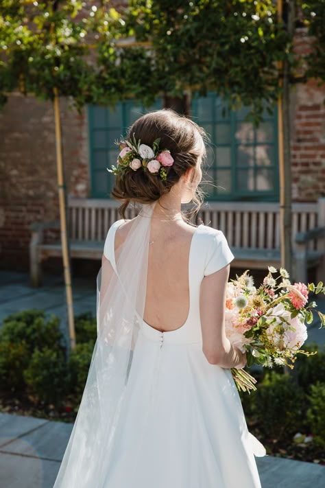 Bride wears a low back Jesus Peiro wedding gown. Images by Helen King Photography #realbride #weddingdress #weddinggown #bridalgown #bridaldesigner #weddingfashion #weddingstyle Early Spring Wedding, Summer Wedding Hairstyles, Literary Wedding, Jesus Peiro, Flower Veil, Spring Wedding Colors, Bridal Hair Flowers, Wedding Hair Flowers, Bohemian Wedding Dresses