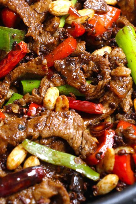 Closeup of Szechuan beef with bell peppers, peanuts and chilis Kung Pow Beef, February Dinners, Kung Pao Beef Recipe, Kung Pao Beef, Autumn Dinners, Mongolian Bbq, Szechuan Beef, Szechuan Recipes, Szechuan Chicken