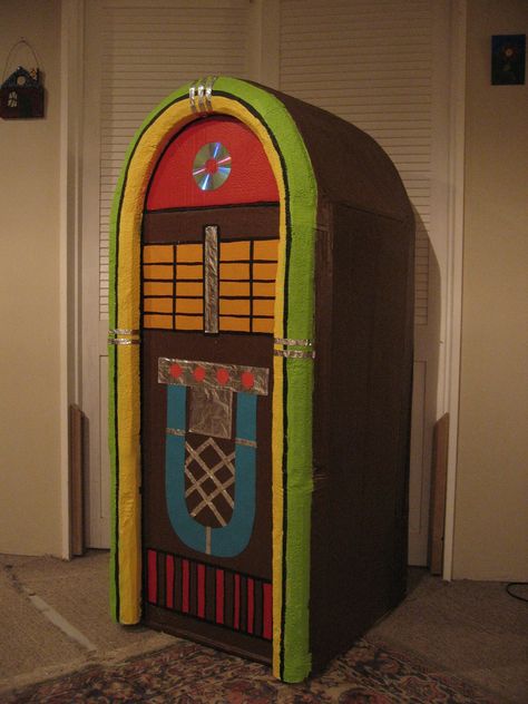 Jukebox stage prop made from large cardboard box. By Kitty Wake All Shook Up Musical Set, Juke Box Diy Cardboard, Diy Jukebox Prop Cardboard Boxes, Diy Jukebox Prop, Cardboard Props, 60s Theme, Kids Stage, Sock Hop Party, Large Cardboard Boxes