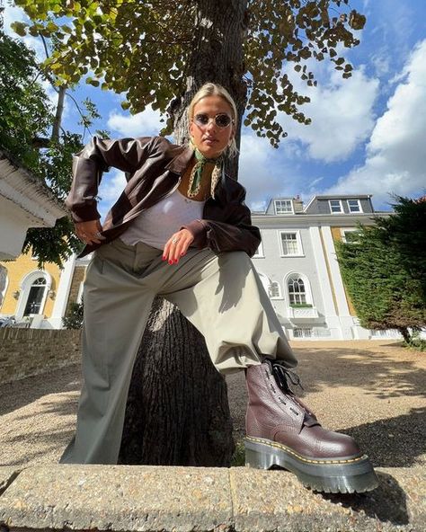 schuh on Instagram: "A boot for every season 🧸 @ToriVanbreugel wears the Dr. Martens Sinclair 📸 ID: An image of a person standing outside in-front of a tree with one foot on a wall wearing burgundy Dr. Martens boots, beige trousers, a white top, burgundy jacket and sunglasses." Brown Jadon Dr Martens Outfit, Dr Martens Brown Outfit, Burgundy Dr Martens Outfit, Burgundy Doc Martens Outfit, Sinclair Dr Martens Outfit, Brown Doc Martens Outfit, Sinclair Dr Martens, Dr Martens Boots Outfit, Burgundy Boots Outfit