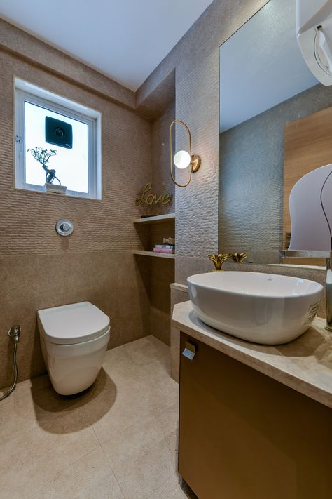 The undertone of this all #beige #washroom screams elegance and #contemporary values. Utilizing a tint of #gold in the form of #wallbracketlight and #decor adds a tinge of #glamour. A #beigecountertop holds a #whitebasin and classic #fittings. The corner niche #shelves has been artfully used for displaying as well as storing items. #aumarchitects #mumbaidesigners #teamaum #luxuryinteriorsbyaum #officeinteriors #washroomdesign #commercialinteriors #upvcwindows #blackexhaustfan #laminate #bronze Washroom With Window, Beige Washroom, Corner Niche, Niche Shelves, Bracket Lights, Washroom Design, Upvc Windows, Contemporary Office, Bathroom Designs