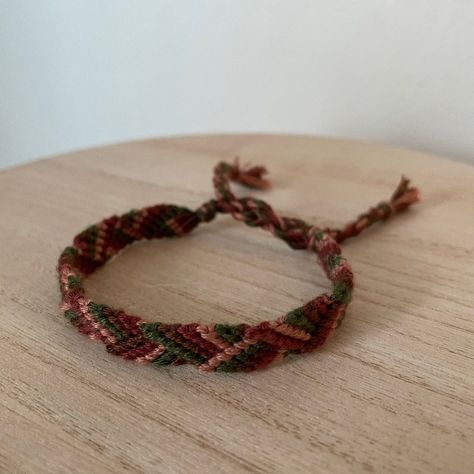 A Handmade Bracelet Woven With Red, Green, And Brown Colors. 10 Bracelets For $25. Red Jasper Bracelet, Bracelet Colors, Colorful Bead Bracelets, Yarn Bracelets, Fall Evening, Thread Bracelet, Knit Bracelet, Embroidery Bracelets, Dark Maroon