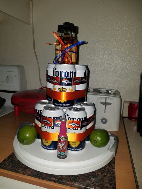 Bronco Corona can man cake. 12 pk can small limes or 1 or 2 regular lime beer salt and 3 of the favorite shooters and ribbon to decorate with.  He's going to think it's cheesy but hey  he wanted a cake! Small Beer Cake, 21st Birthday Beer Cake For Guys, Beer Cakes For Men, Beer Can Birthday Cakes For Men, Beer Can Cakes For Men Diy, Beer Can Cake Tower, Soda Can Cake Tower Diy Birthday Gifts, Beer Salt, Beer Can Cakes