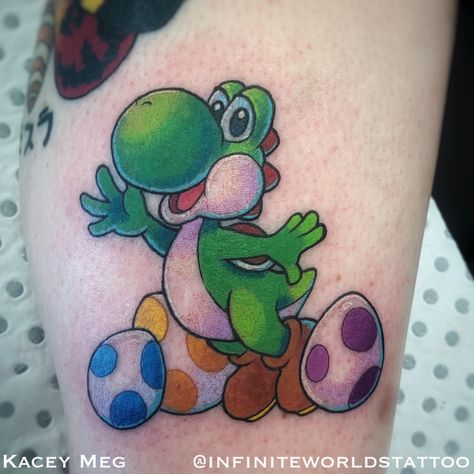 Yoshi tattoo   Tattoo by Kacey Meg from Infinite Worlds Tattoo and Design Small Yoshi Tattoo, Yoshi Tattoos, Yoshi Tattoo, Nintendo Tattoo, Mario Tattoo, Gaming Nintendo, Embroidery Tattoo, Miami Ink, Petit Tattoo