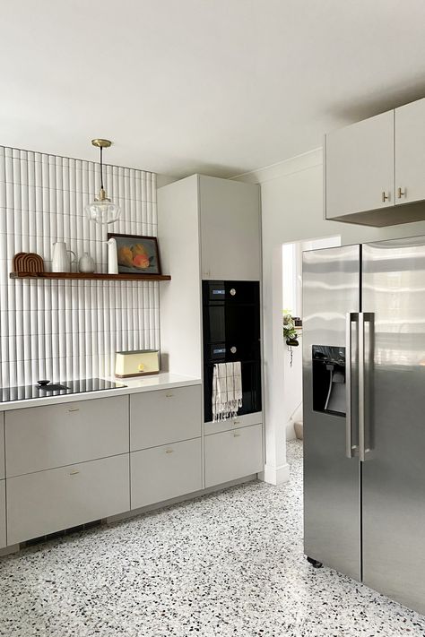 The new brown-and-black-speckled terrazzo floor from Diespeker & Co. replaced the existing mock wood vinyl. The brass cabinet pulls are Watt T-Bar Handles from Plank Hardware. “I thought VERY HARD about how to keep existing elements,” Ferren Gipson tells us. “I considered preserving the base cabinets and replacing the appliances and doors, but the cabinets that were there just didn’t make the most of the space and wouldn’t have allowed us to fit as much in.” Terrazzo Kitchen Flooring, Terrazzo Floors Kitchen, Terazzo Kitchen Wall, Kitchen With Terrazzo Floors, Kitchen Terrazzo Floor, Terrazzo Floor Kitchen, Terrazzo Flooring Kitchen, Terrazzo Kitchen Floor, Kitchen Terrazzo