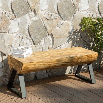 Durable, fade-resistant patio bench features a natural wood look that emulates the beauty and luster of wood without the care and high maintenance needed for real wood. This bench is constructed of weather-resistant, fire retardant, natural inorganic terra ab material that is eco-friendly and extremely durable to withstand the natural environment. | Earth D Tree Trunk Style Concrete Garden Outdoor Bench Stone / Concrete in Black / Brown / Gray | 18 H x 48 W x 16 D in | Wayfair Live Edge Bench Outdoor, Stone Benches Outdoor Diy, Stone Benches Outdoor, Tree Trunk Ideas Diy, Log Benches Outdoor, Tree Trunk Decor, Benches For Outside, Tree Trunk Bench, Rustic Outdoor Bench