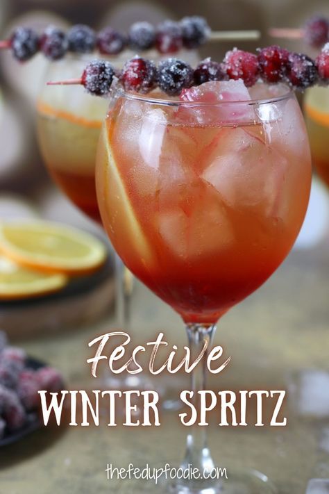 With orange liqueur, cranberry simple syrup, Prosecco and sparkling water, this Winter Spritz is a festive drink for Christmas, New Years or winter parties. #WinterSpritz #WinterSpritzCocktail #ChristmasSpritzer #ChristmasSpritzerDrink #ChristmasSpritzCocktail Winter Spritzer Drinks, Christmas Spritzer Drink, Winter Spritz, New Years Drink, Cranberry Spritz, Spritzer Drink, Christmas Spritz, Spritz Cocktails, Cranberry Simple Syrup