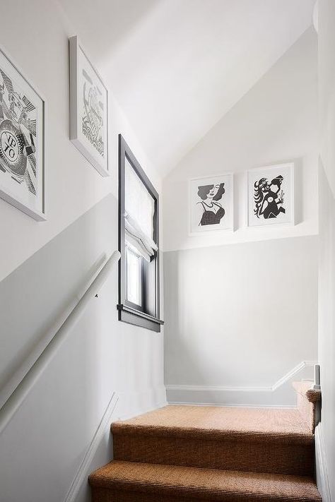 Two-toned walls design a staircase with artistic black and white wall art in white frames. 1920 Home Remodel, Stairway Paint Ideas, Staircase Wall Painting Ideas, Hallway Wall Colors, Half Painted Walls, Stairwell Wall, Walls Design, Grey Hallway, Two Tone Walls