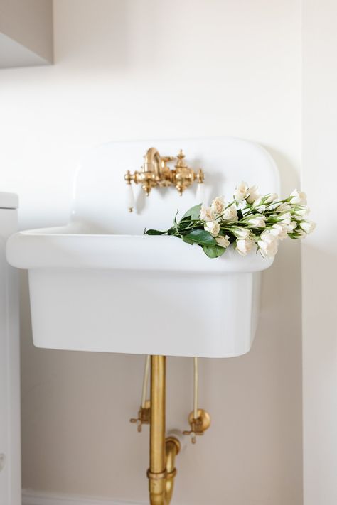 Adding a wall mount sink to a bathroom, utility space or laundry room is the ultimate way to add a touch of vintage charm. They are hard-working, space-saving and so easy on the eyes! We're sharing the pros and cons of this style of sink, as well as shopping inspiration if you're on the hunt. Whether you're looking for a modern wall mounted sink, or a ceramic wall mount farmhouse sink like ours, we've got the sources in this curated guide! Wall Mounted Utility Sink, Bathroom Utility, Exposed Plumbing, Utility Space, Wall Hung Sink, Wall Mount Sinks, Painted Concrete Floors, Julie Blanner, Wall Mount Sink