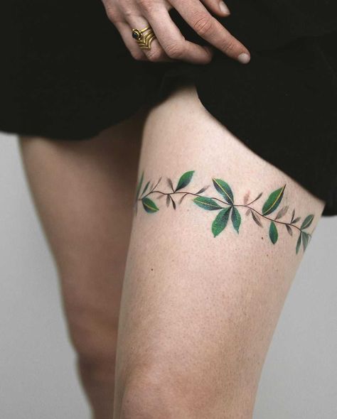 Leaves wrapped around the left thigh by Rey Jasper Tattoos For Women 2023, Leg Tattoos For Women, Thigh Band Tattoo, Upper Leg Tattoos, Thigh Tattoo Men, Side Thigh Tattoos, Garter Tattoo, Flower Thigh Tattoos, Thigh Tattoo Designs