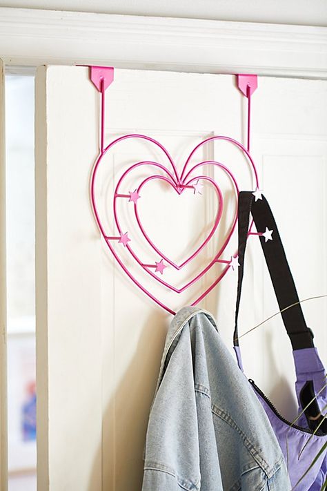 Show your space some love with this iron-crafted over-the-door hook featuring a heart silhouette with seven hooks scattered throughout with star icons at the end of each. Available exclusively at Urban Outfitters. Features Shaped over-the-door multi-hook from UO Home Heart silhouette for a whimsical feel 7 Hooks Versatile - use it to hang your bags, coats, scarves & other accessories UO exclusive Content + Care Iron Wipe clean Imported Size Dimensions: 14.4" l x 3.75" w x 17" h Weight limit: 2.2 Iconic Room Decor, Bag Hanger Ideas, Door Decorations Bedroom, Bedroom Door Decor, Dorm Room Supplies, Weird Furniture, Heart Silhouette, Door Hook, Pinterest Contest