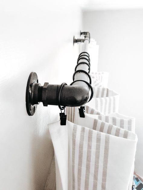 Use PVC pipe and a few other basic supplies to to make your own DIY industrial curtain rod for less than $25. Cottage Window Treatments, Roll Down Shades, Cheap Curtain Rods, Pipe Curtain Rods, Wrap Around Curtain Rod, Industrial Curtain Rod, Iron Curtain Rods, Industrial Curtains, Diy Home Updates