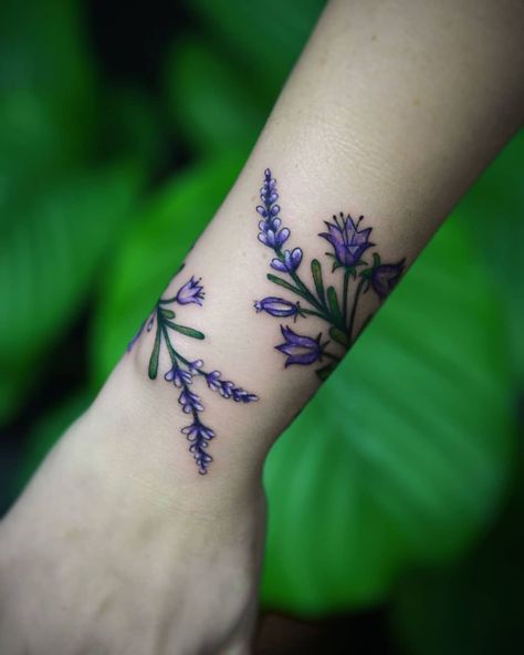 Guide to Flower Tattoos, Meaning, Design Ideas & Placements Daisy Tattoo On Wrist, Tiny Daisy Tattoo, Violets Tattoo, Violet Tattoo Flower, Flower Tattoo Placement, Purple Flower Tattoos, Violet Flower Tattoos, Lavender Bunch, Cute Tattoos With Meaning