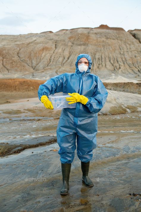 Female scientist in protective coveralls, respirator, rubber gloves and boots by Pressmaster. Young female scientist in protective coveralls, respirator, rubber gloves and boots holding plastic container with wa... #Sponsored #respirator, #rubber, #gloves, #coveralls Hazmat Suits, Female Scientist, Rainwear Girl, Gas Mask Girl, Hazmat Suit, Women Scientists, Plastic Clothes, Mask Girl, Rubber Gloves