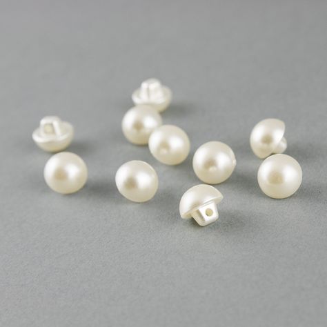 These small hemispherical buttons are ideal for button placket closures on wedding dresses and blouses, as well as for narrow sleeve cuffs where the buttons should be close together. The buttons have a diameter of approx. 9 mm and are in classic ivory/ivory. The surface has a beautiful pearl shimmer, the buttons are sewn a short distance apart and resemble a pearl necklace. These buttons can be found on many wedding dresses and can be sewn into the bottom through a hole on the stem. One pack con Pearl Buttons Wedding Dress, Wedding Dress Buttons, Holiday 2024, For Wedding Dress, Shirt Cuff, Dresses Lace, Pearl Buttons, Ivory Color, Button Placket